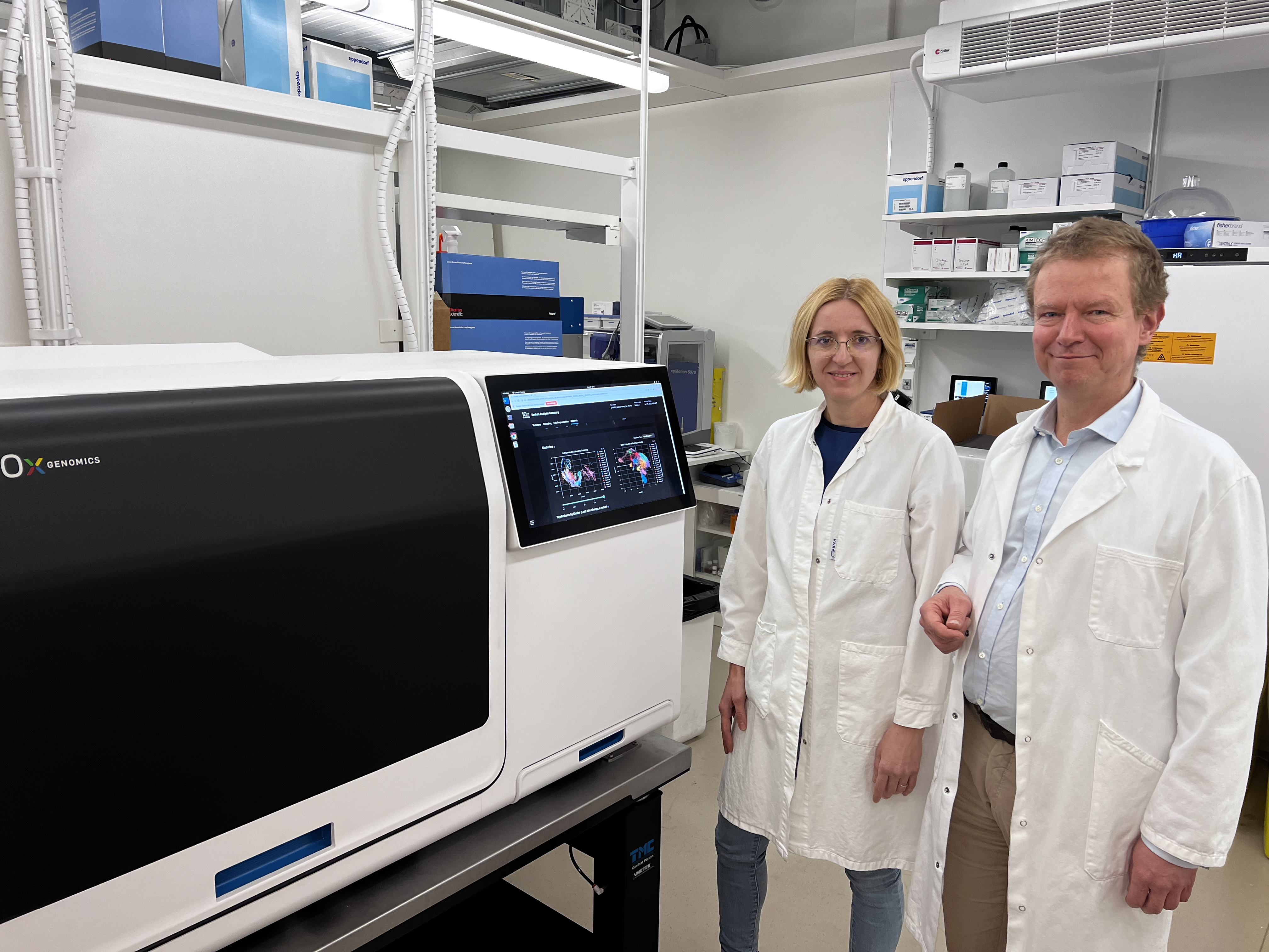 Mats Nilsson, PhD (right) and Katarina Tiklova, PhD (left) standing with the Xenium Analyzer.
