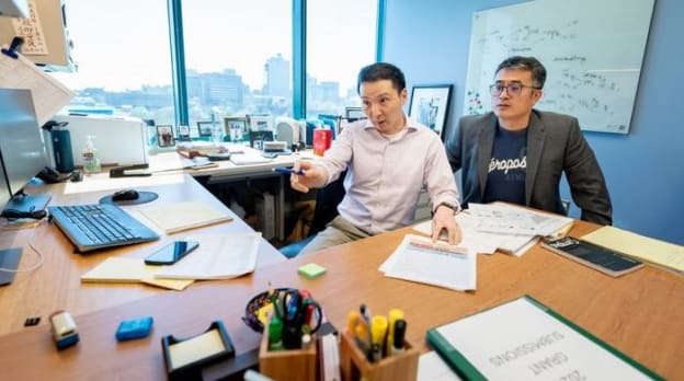 Two researchers looking at data